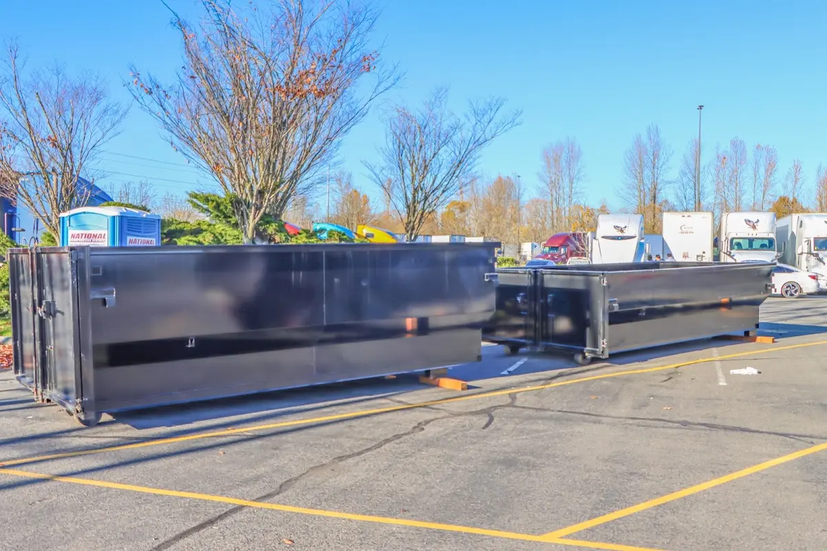 Professional dumpster rental service with roll-off container on residential driveway in Hoquiam